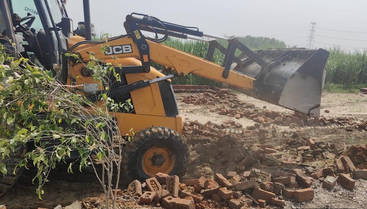 Bulldozers razed four illegal plotted developments on Modinagar Road.