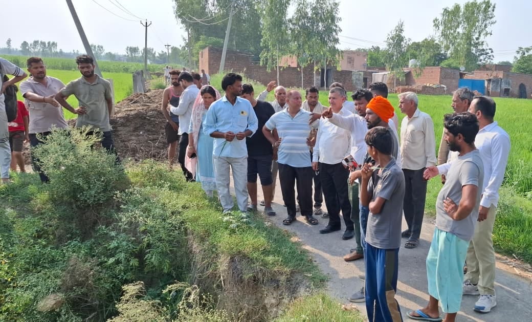 Villagers protest against the action taken regarding the drain dispute.