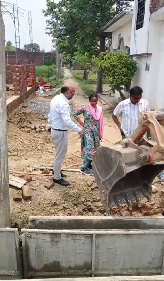 The wall of a drain under construction was demolished using a JCB.