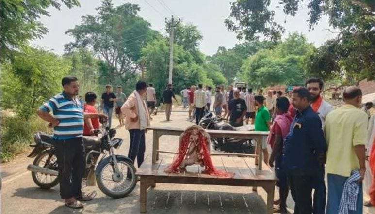 Idol of the Goddess dumped by the riverside; angry locals stage a road blockade.