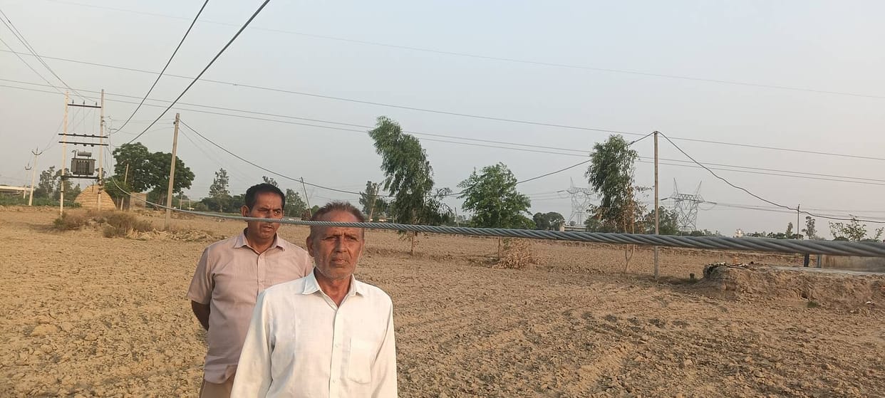Electric wires hanging in the fields.