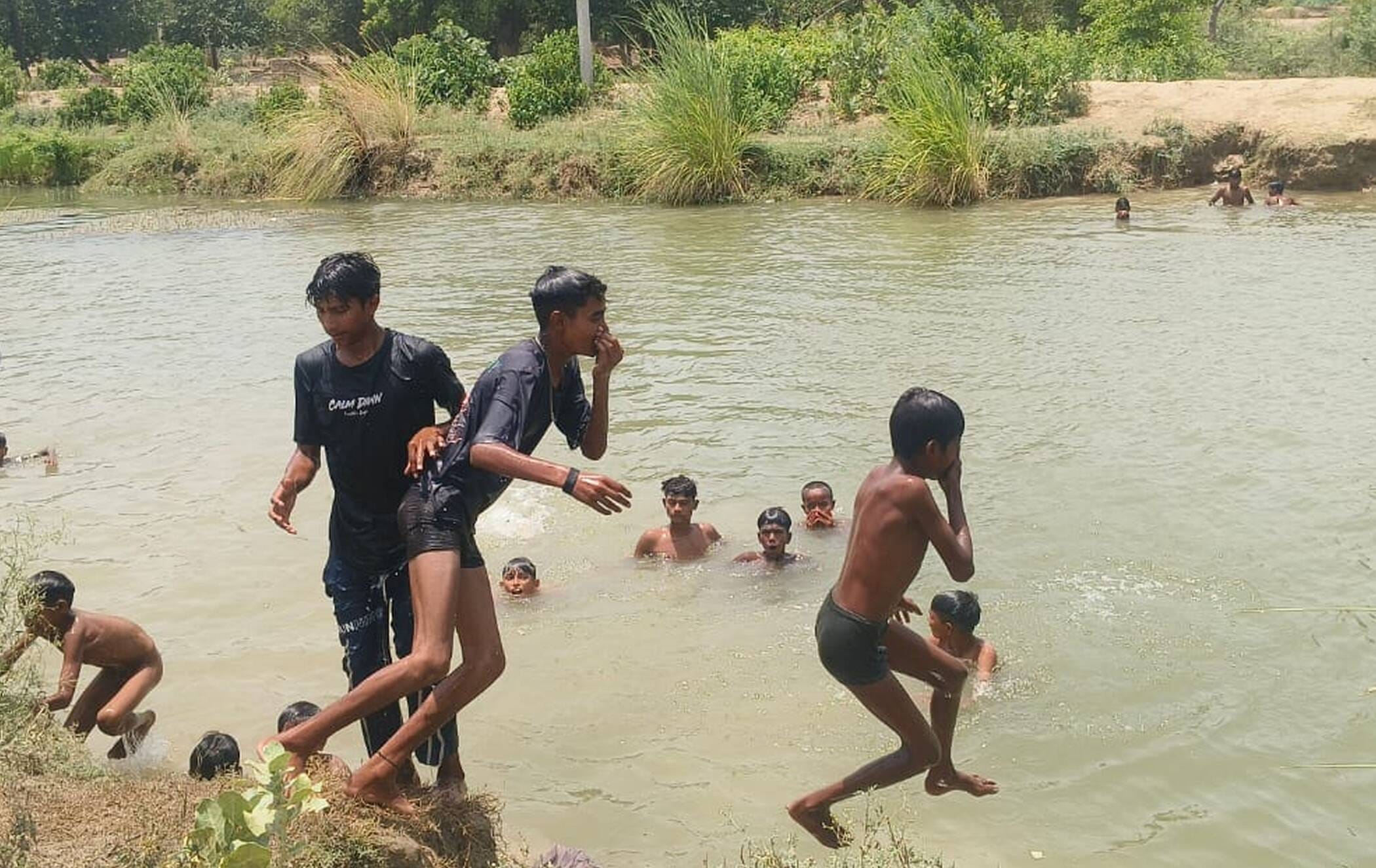 फोटो-35-असोथर स्थित बड़ी नहर में दोपहर के समय नहाते बच्चे। संवाद
