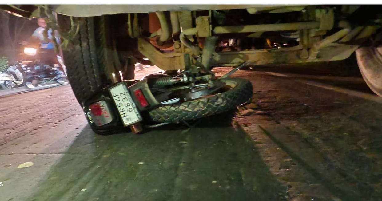 Youth dies after bike runs under truck; companion injured