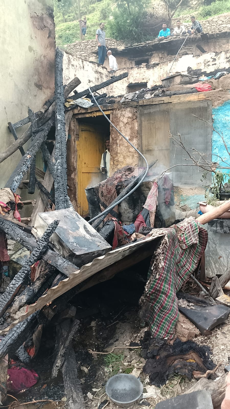 Houses and cowsheds belonging to two families were gutted by fire; a cow died of suffocation.