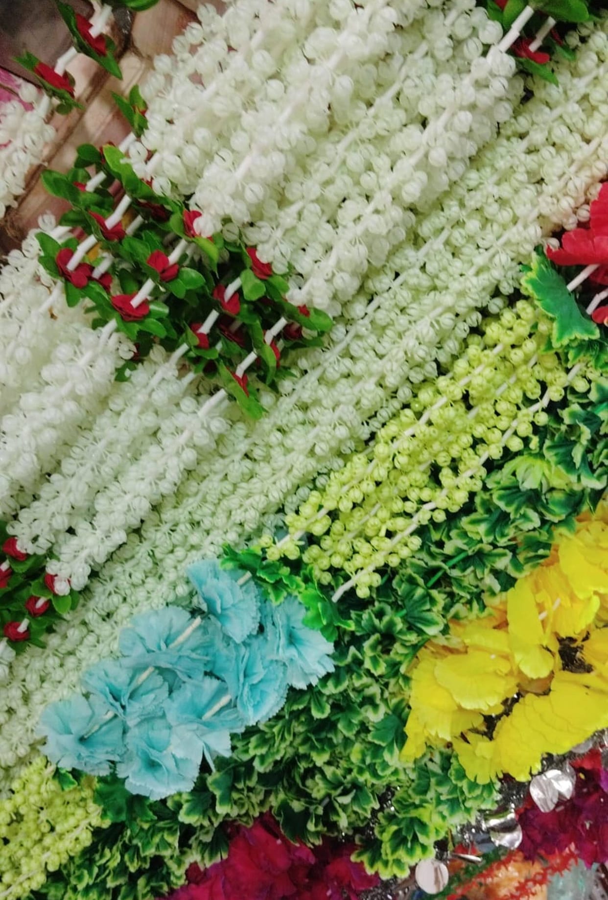 High cost of flowers drives a shift away from them; demand for artificial decoration rises during the wedding season.