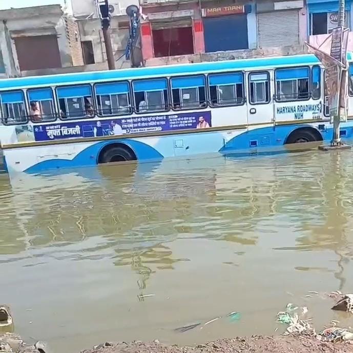 Dharuhera-Bhiwadi bypass submerged after embankment breach; foul-smelling water enters residential colonies.