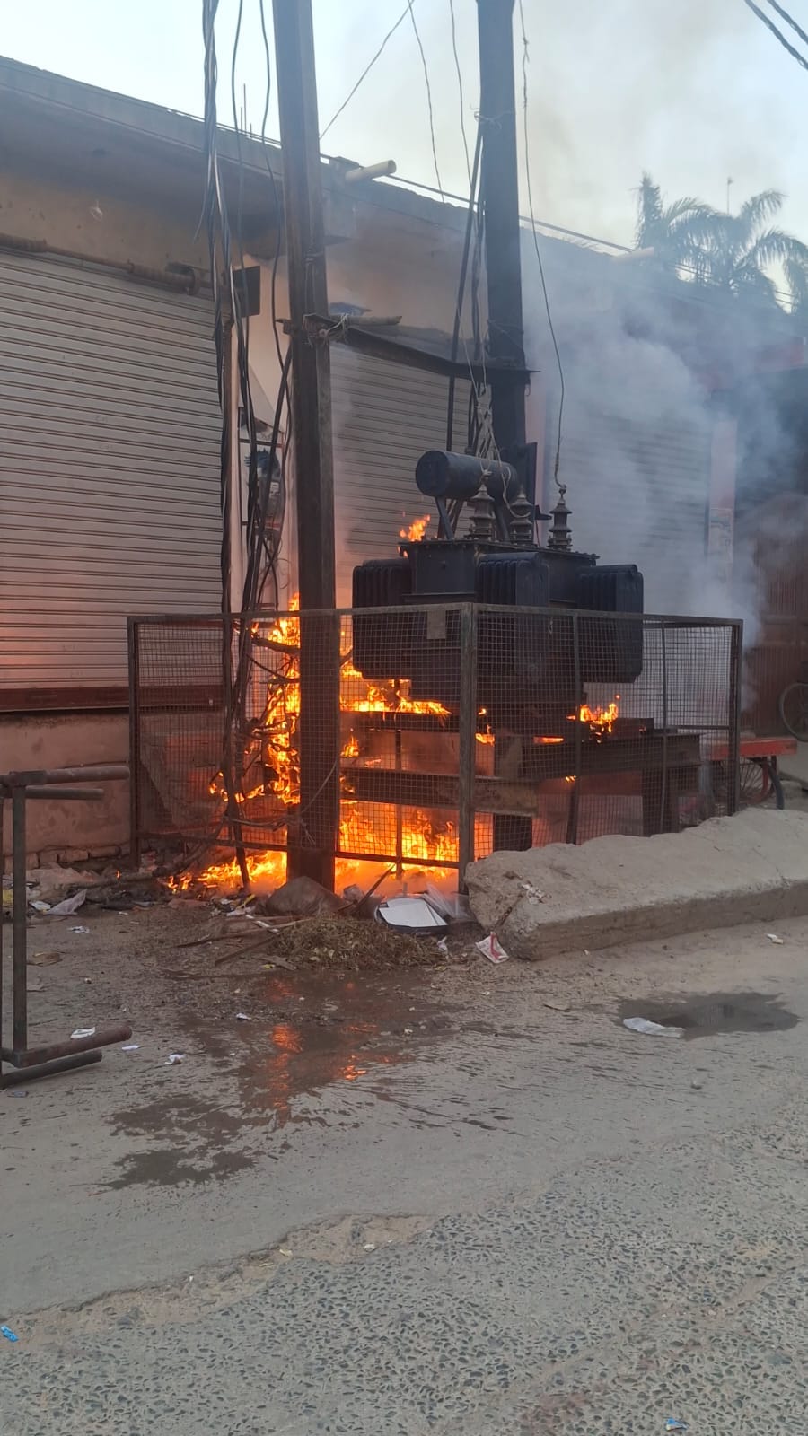 Panic ensued upon seeing flames rising from the trash lying beneath the transformer.