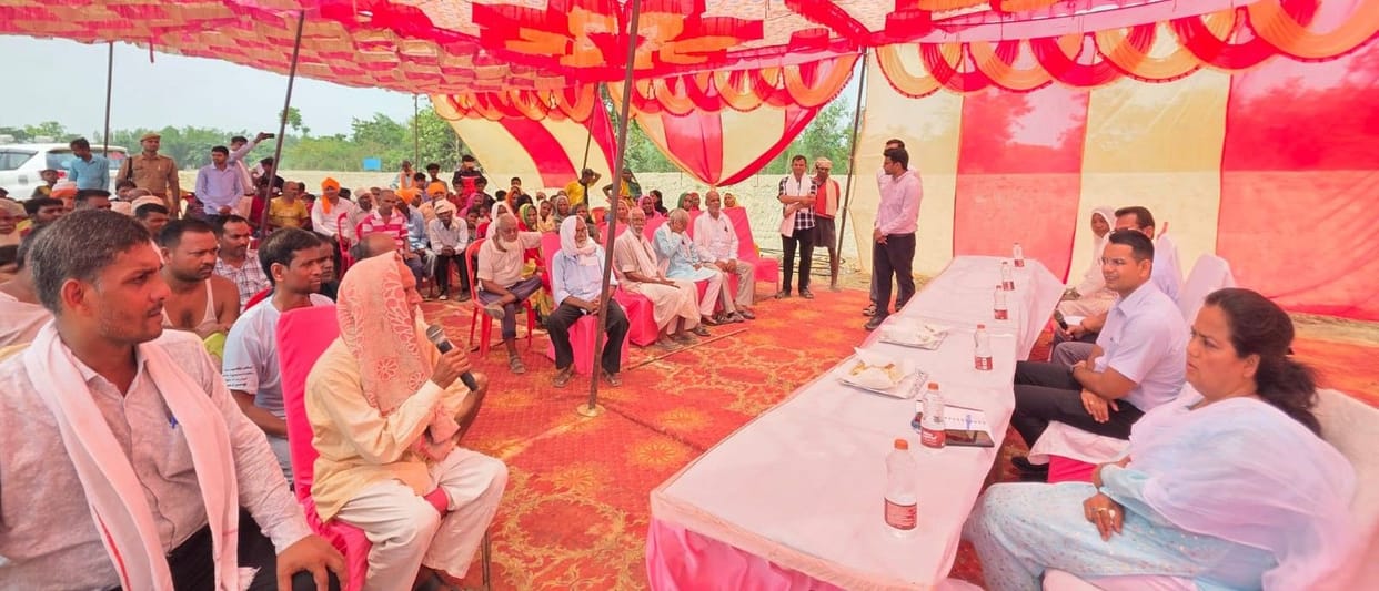 DM holds a public meeting in the village and reviews preparations