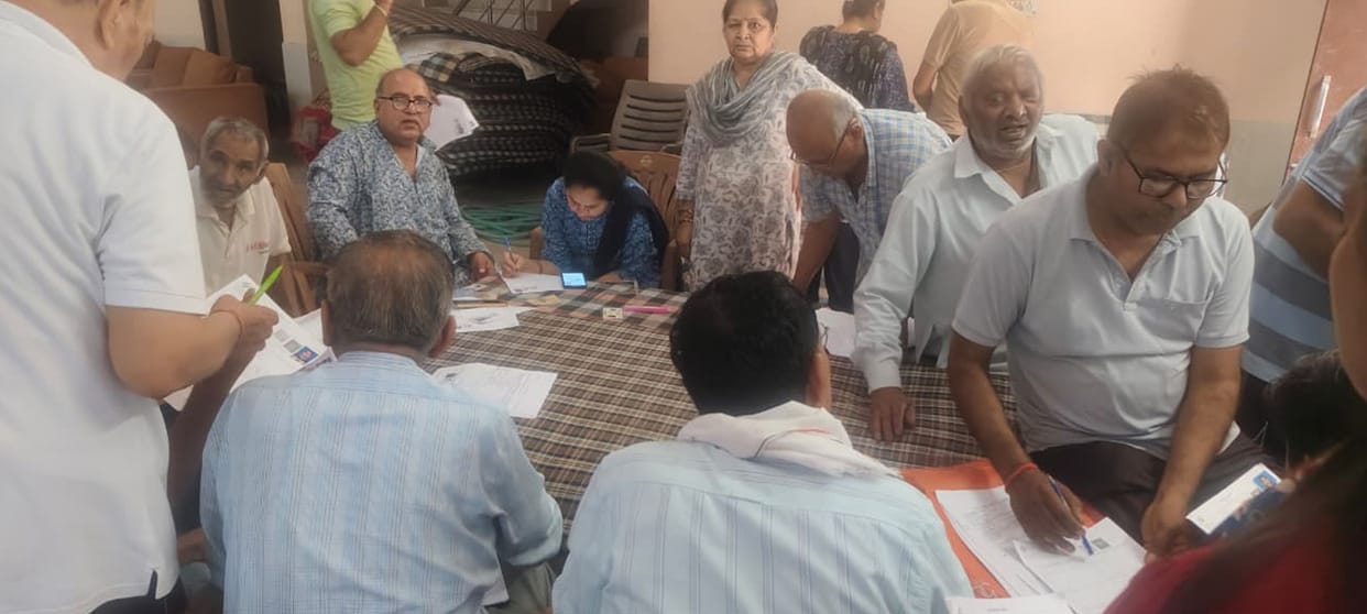 Councilors and booth workers busy getting SIR forms filled out.