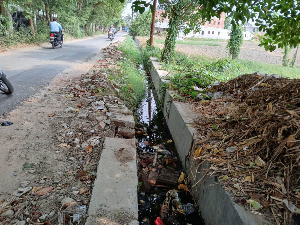 Rain overhead, the city's drains clogged with garbage