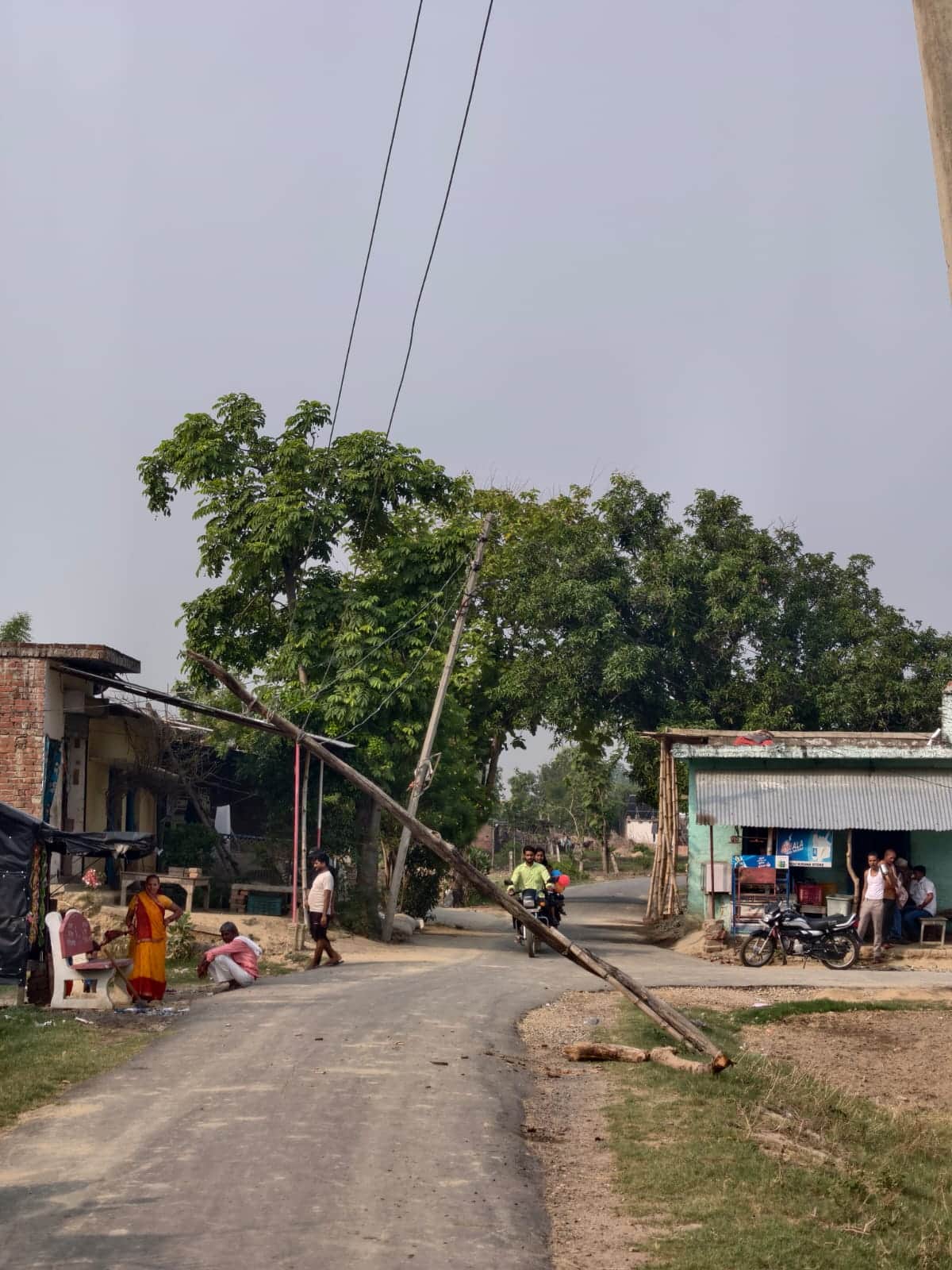 Wire dangling over the road; risk of accident.