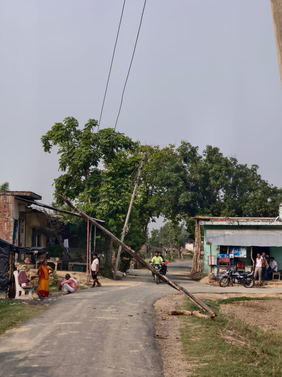 Wire dangling over the road; risk of accident.