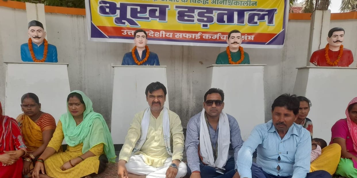 Sanitation workers on a hunger strike near the statues of martyrs.