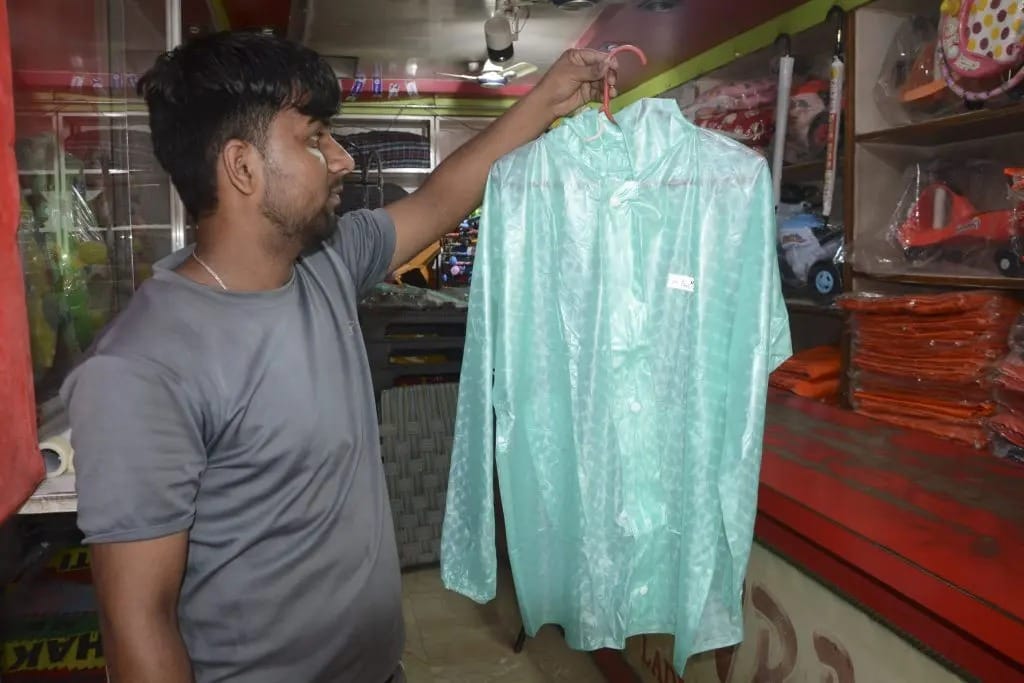The arrival of the monsoon has led to increased activity in shops selling raincoats, shoes, and slippers.