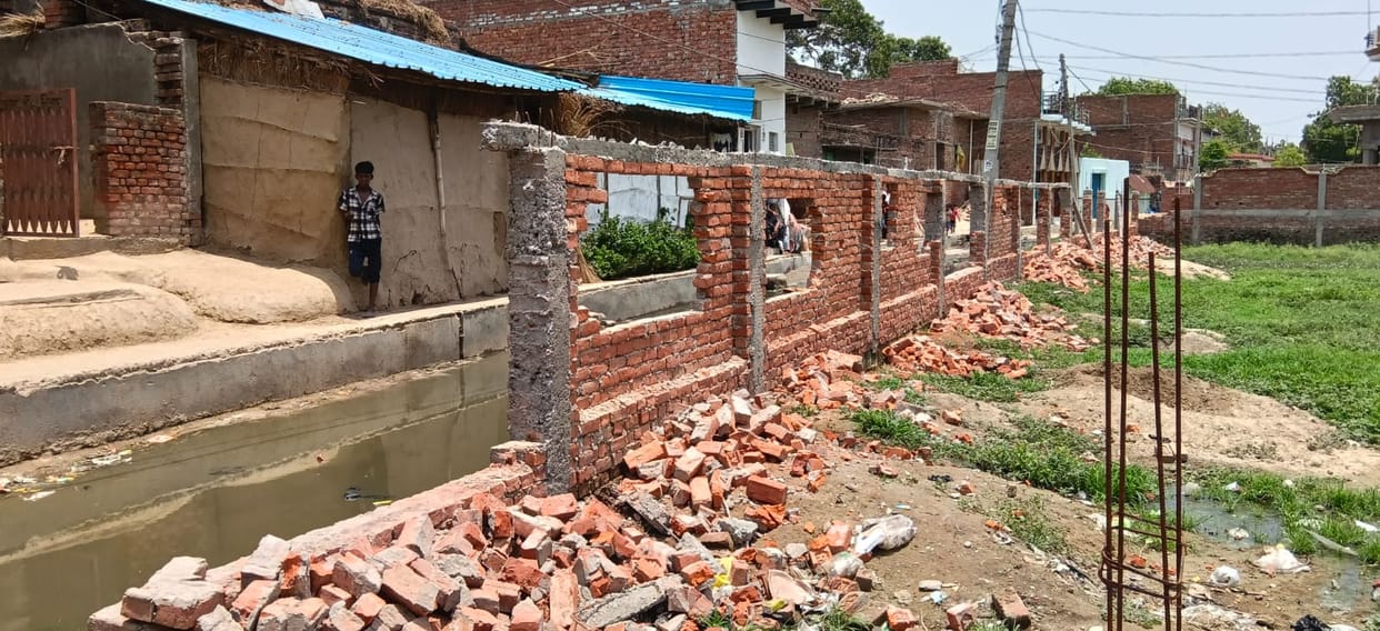 Two groups clash over a drainage dispute; boundary wall demolished.