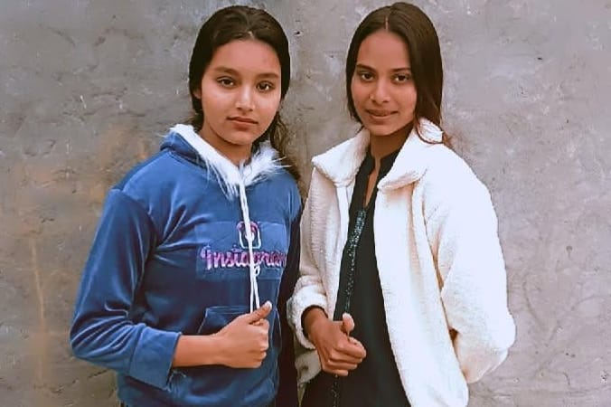 Two sisters riding a bike die after being hit by a container truck.