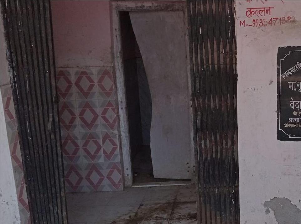 Sulabh toilet doors are dilapidated; filth is scattered around.