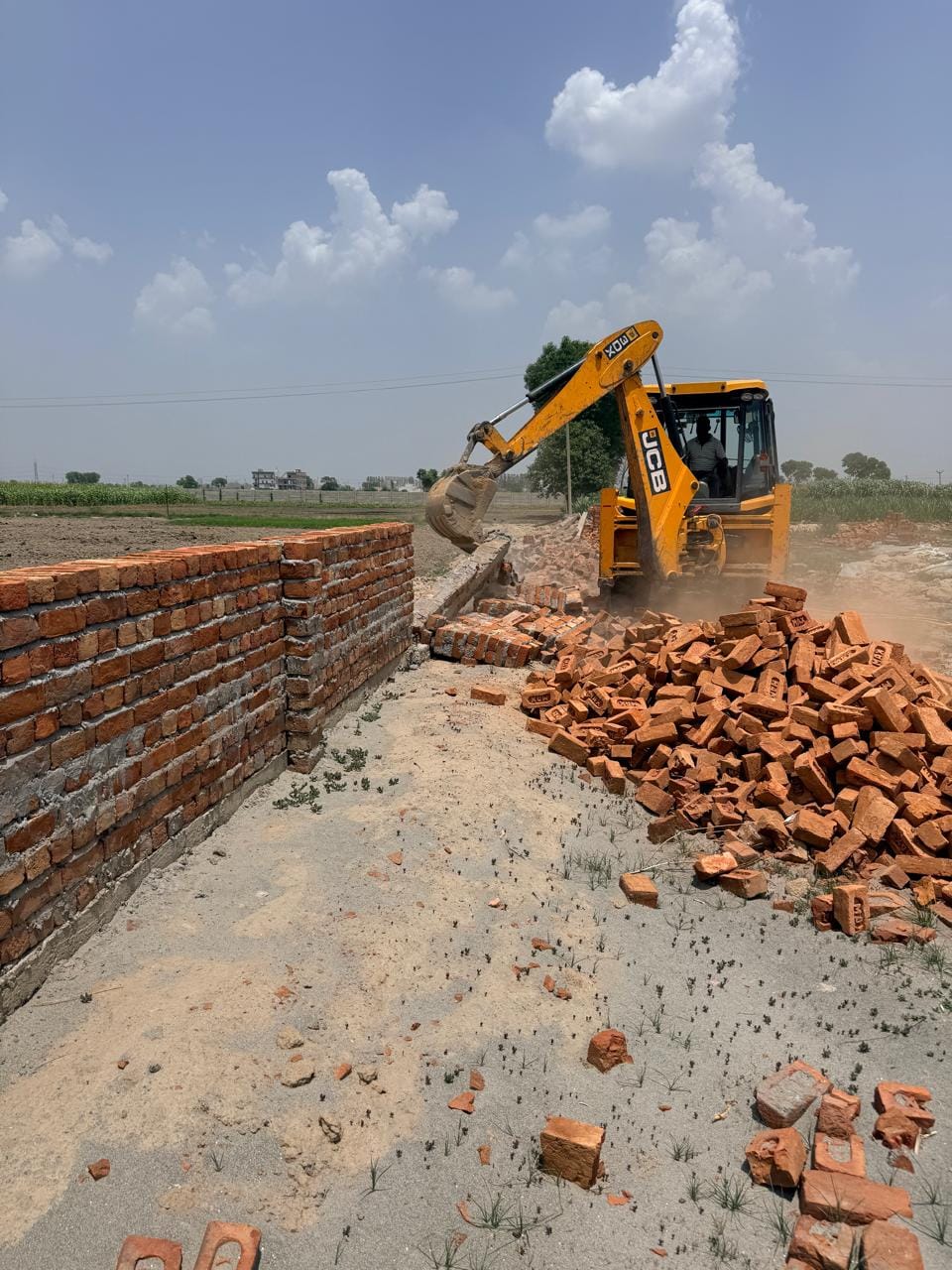 Administration's bulldozer razes illegal colony.