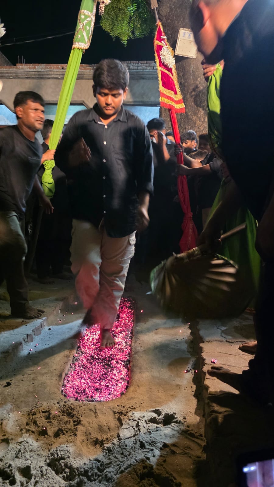 Mourning performed by walking on embers; Imam Hussain's son remembered.