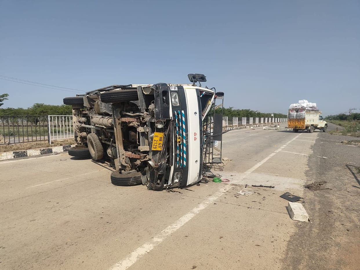 Truck loaded with sacks overturns on national highway.