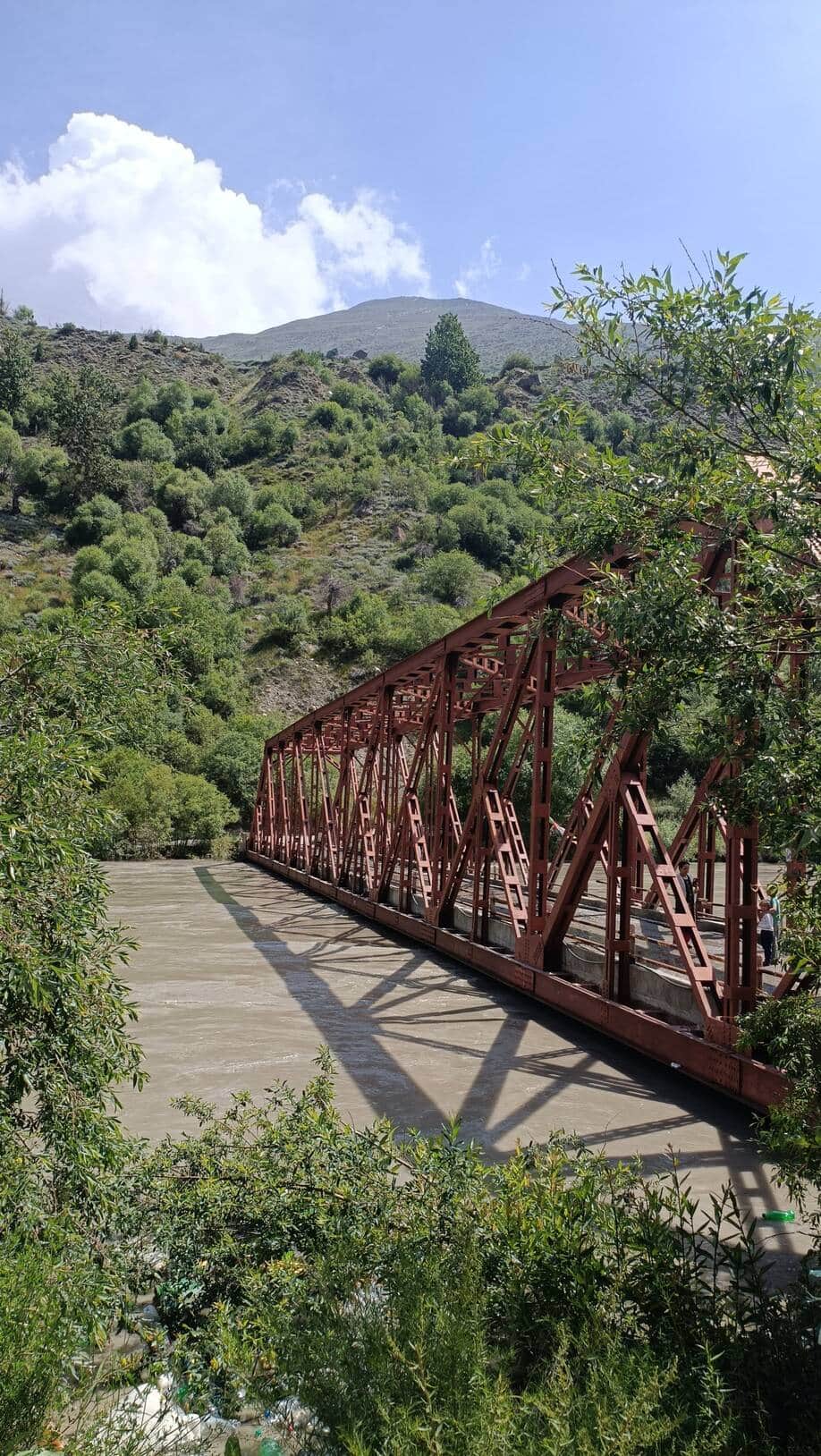 Water from the Chenab flowing over the Jobrang Bridge due to rising water levels.