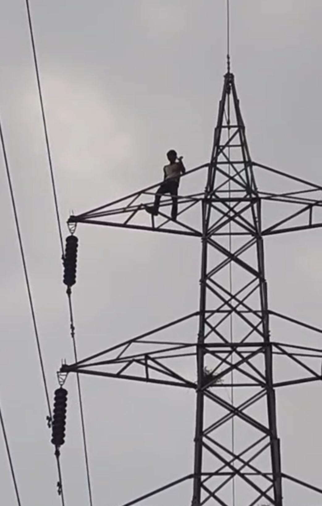Youth climbs electricity tower, insisting on taking his girlfriend along.
