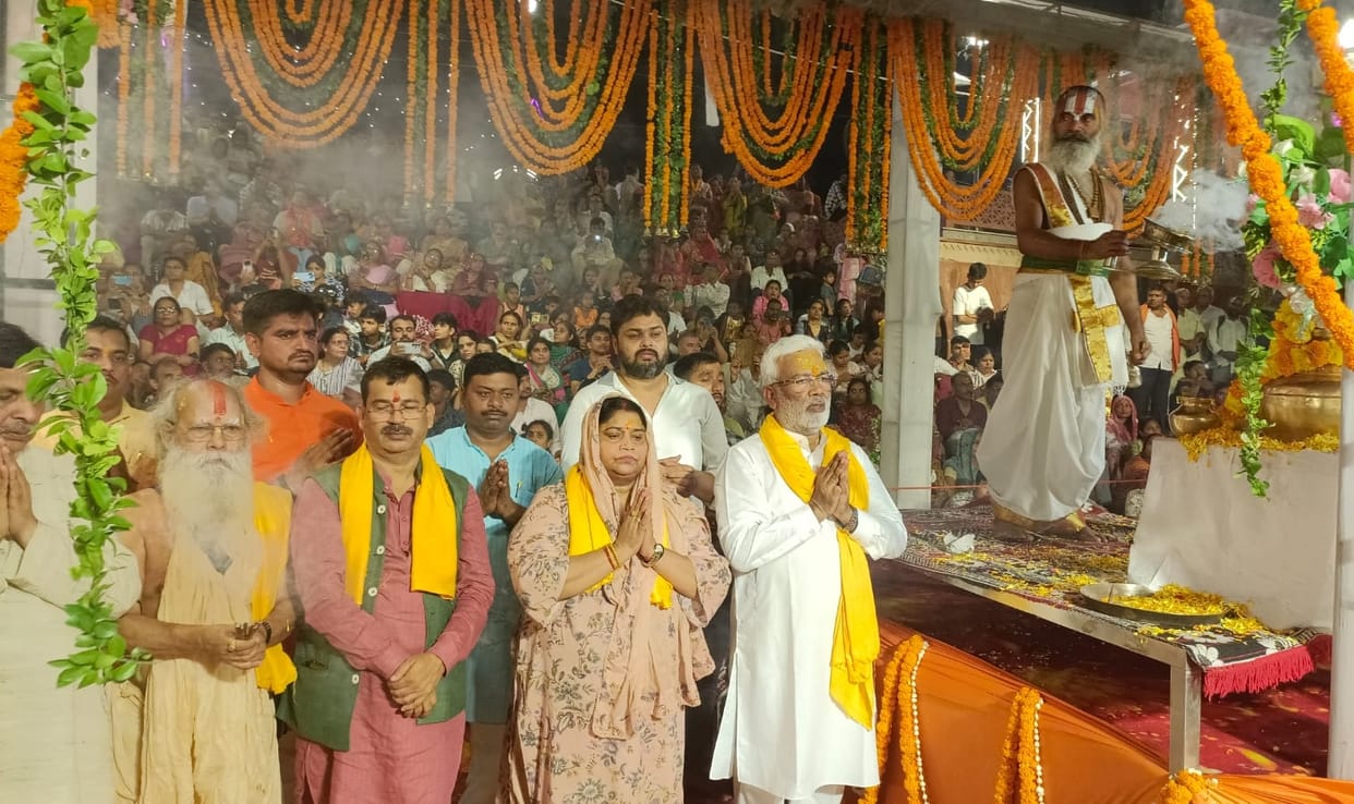 Saryu banks fragrant with flowers and illuminated by a *diya* *aarti* on Saryu Jayanti