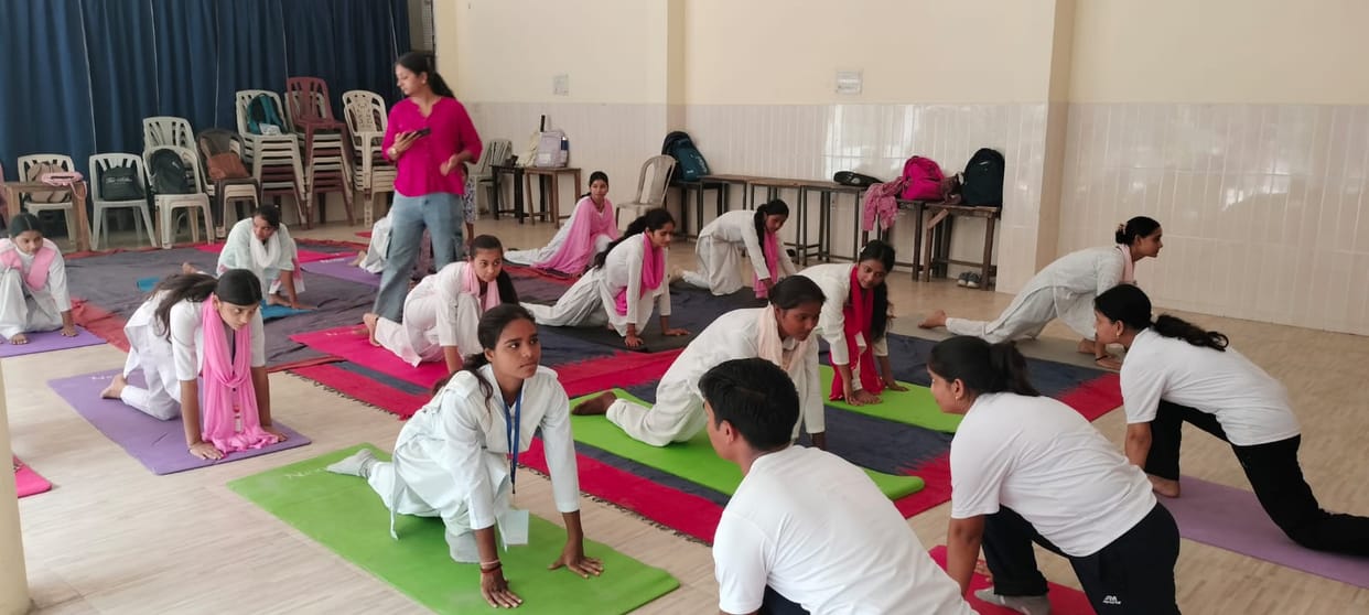 Female students were guided through yoga asanas, and the benefits were also explained.