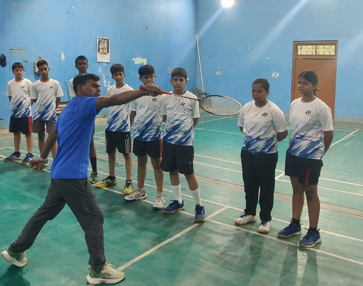 Players learning advanced badminton techniques at the camp.