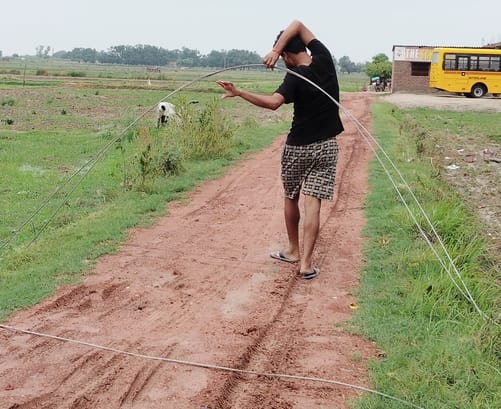 High-tension wire lying in the fields; risk of accident.