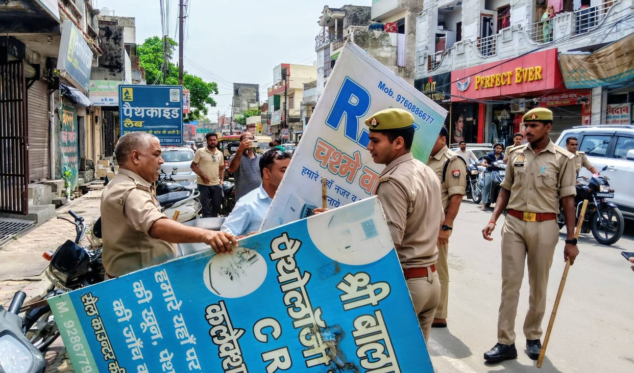 Encroachments removed from the main road; 8 cars and 15 bikes fined.