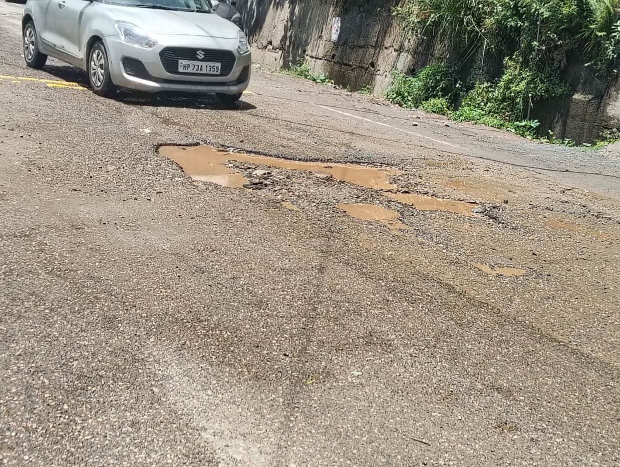 Rain washed away the soil filled into the potholes on the NH.