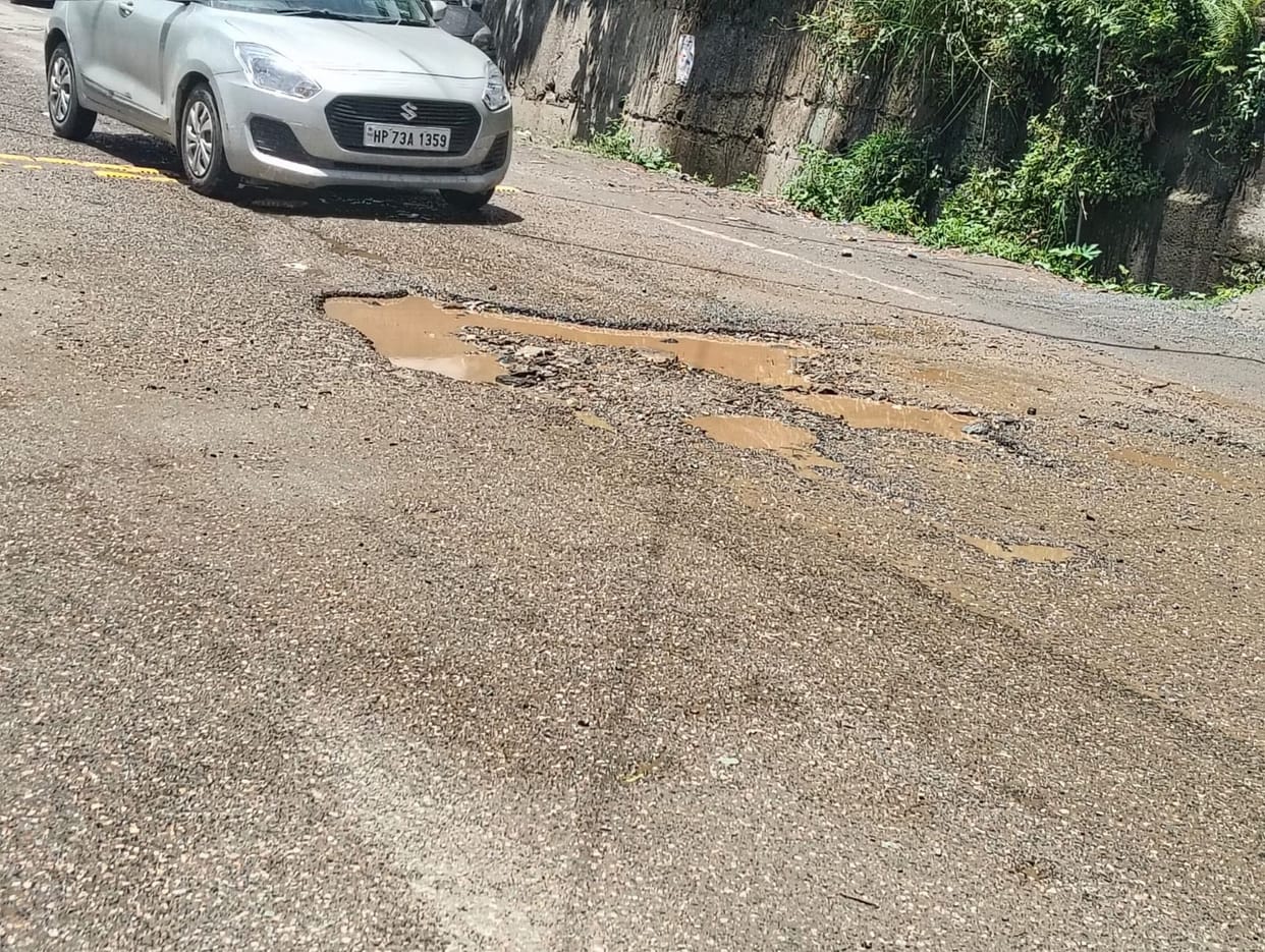 Rain washed away the soil filled into the potholes on the NH.
