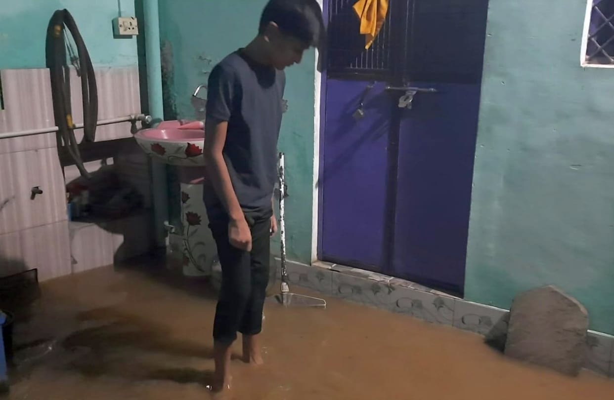 Drains overflowed; water entered homes and shops.