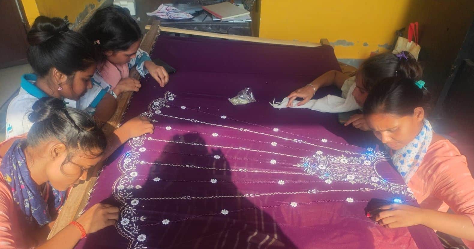 फोटो-1-मियागंज के कॉमन फैसिलिटी सेंटर में कढ़ाई का प्रशिक्षण लेती युवतियां। संवाद