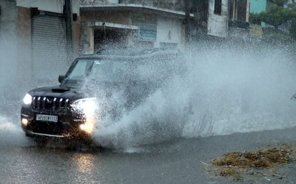 Heavy rains have brought pleasant weather, overflowing drains, and flooded roads.