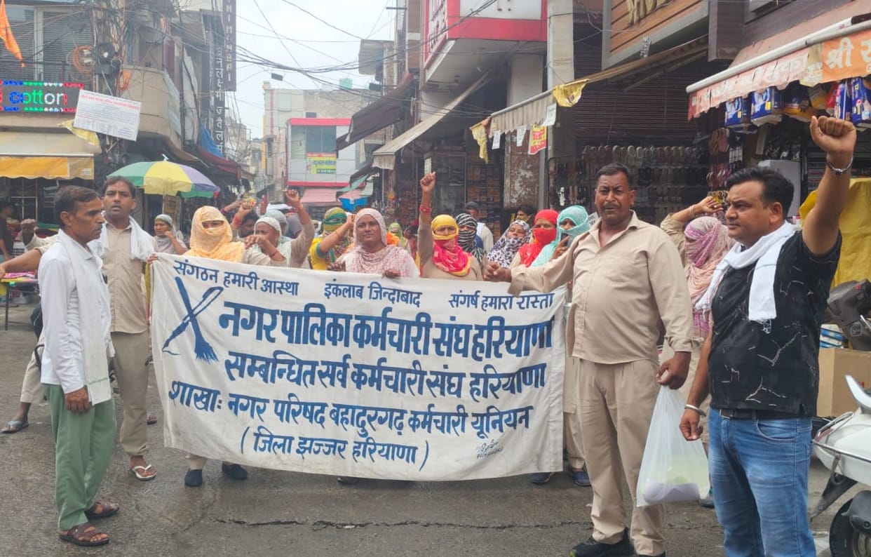 Sanitation workers stage 'broom protest' over unfulfilled promises.