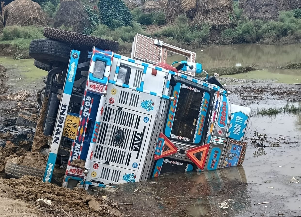 Alternative route on Gajraula-Barkhera road caves in; cement-laden truck overturns.