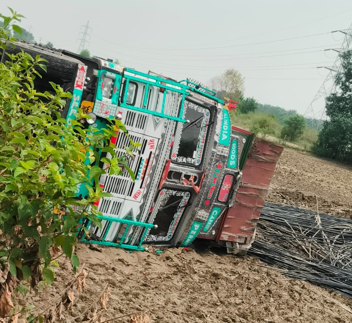 Truck loaded with iron rods overturns; three crushed to death.