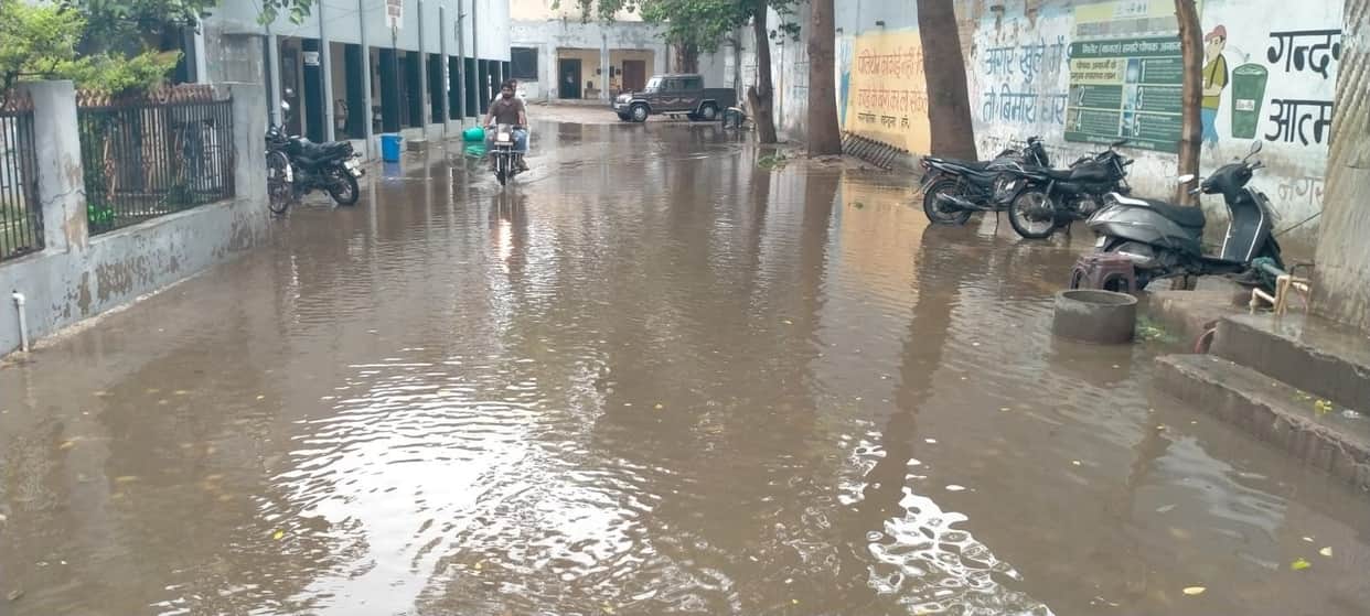 Waterlogging after the first rain; vehicle movement slows to a crawl.