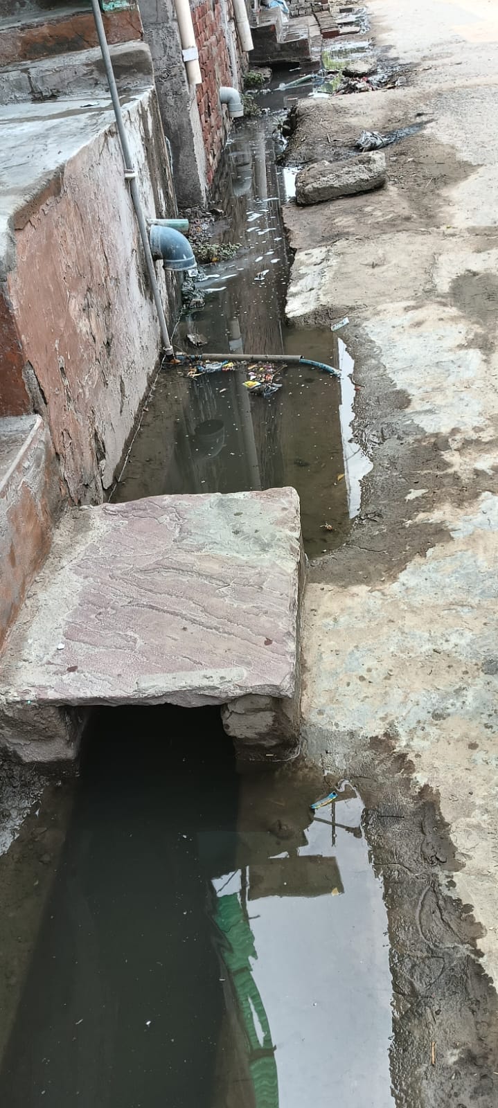 Drains clogged with silt; water entering homes.