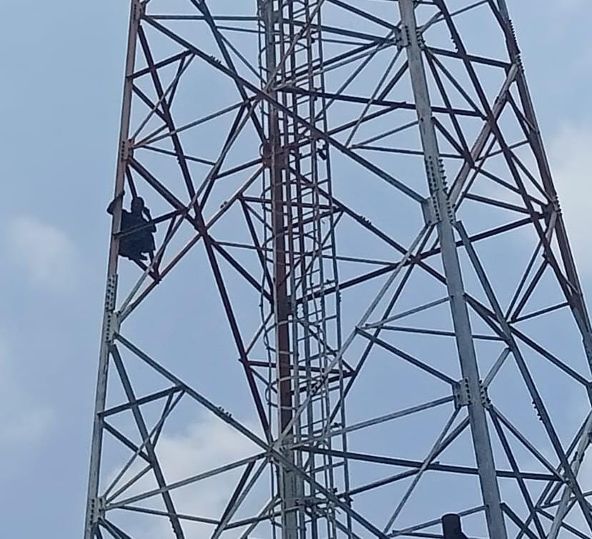 Woman climbs tower after no action is taken on her complaint.
