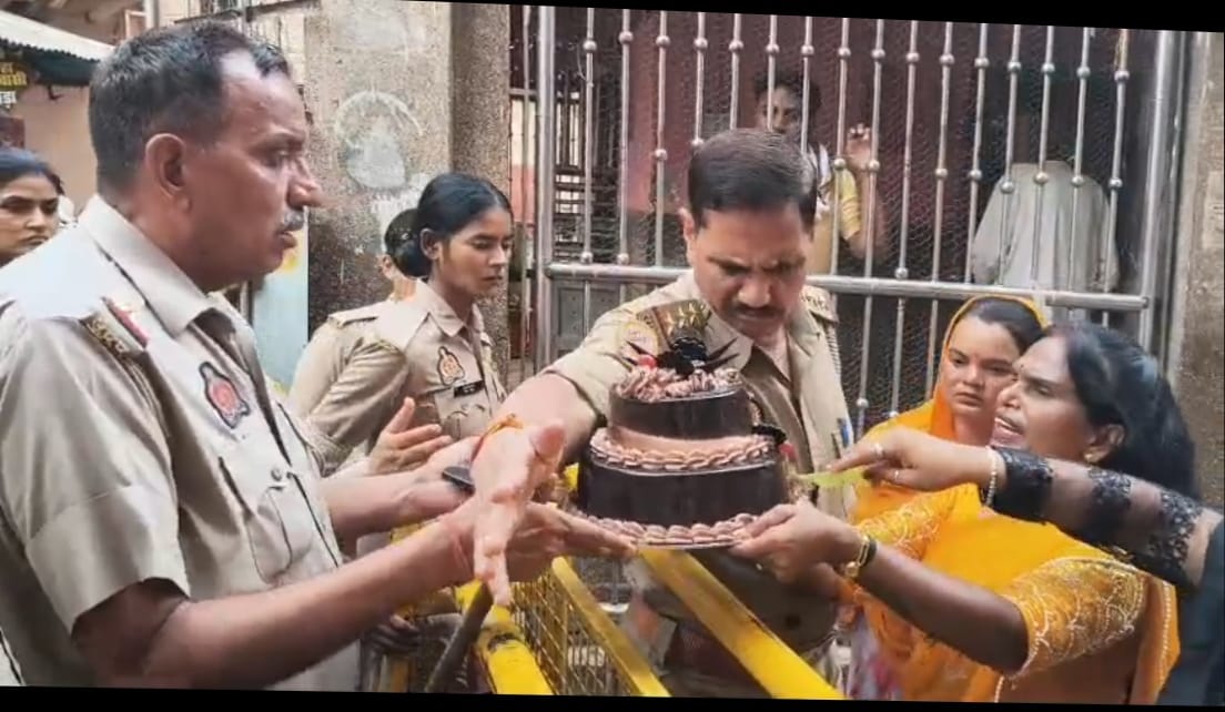When stopped from taking a cake into the Shri Banke Bihari Temple, they cut it outside.