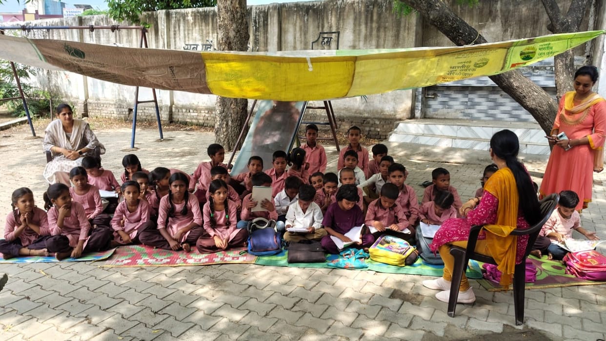 Dilapidated building demolished, children studying under the open sky