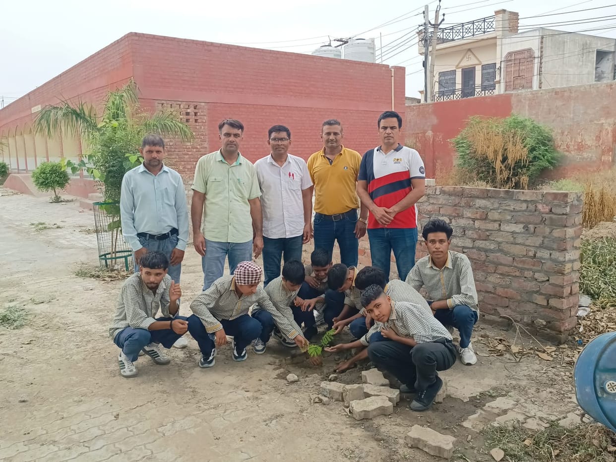 Students pledged to protect the environment by planting saplings.