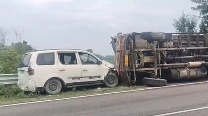 Truck loaded with cattle feed overturns after losing control; major accident averted.