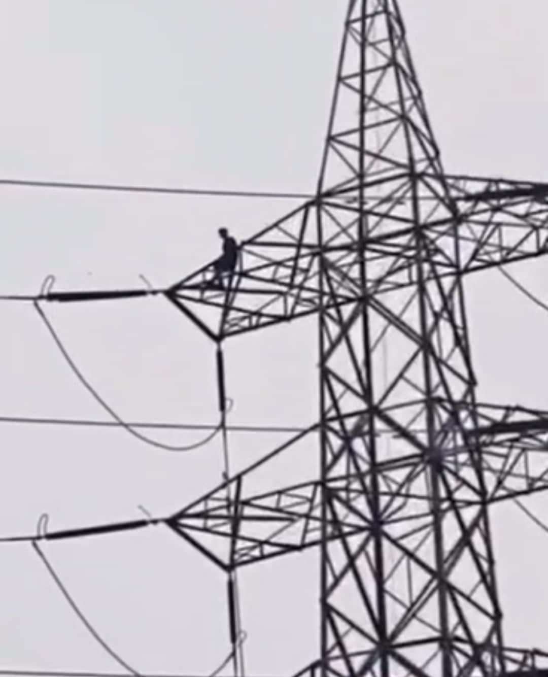 Young man climbs high-tension tower in shock over a broken relationship; brought down safely after a five-hour ordeal.