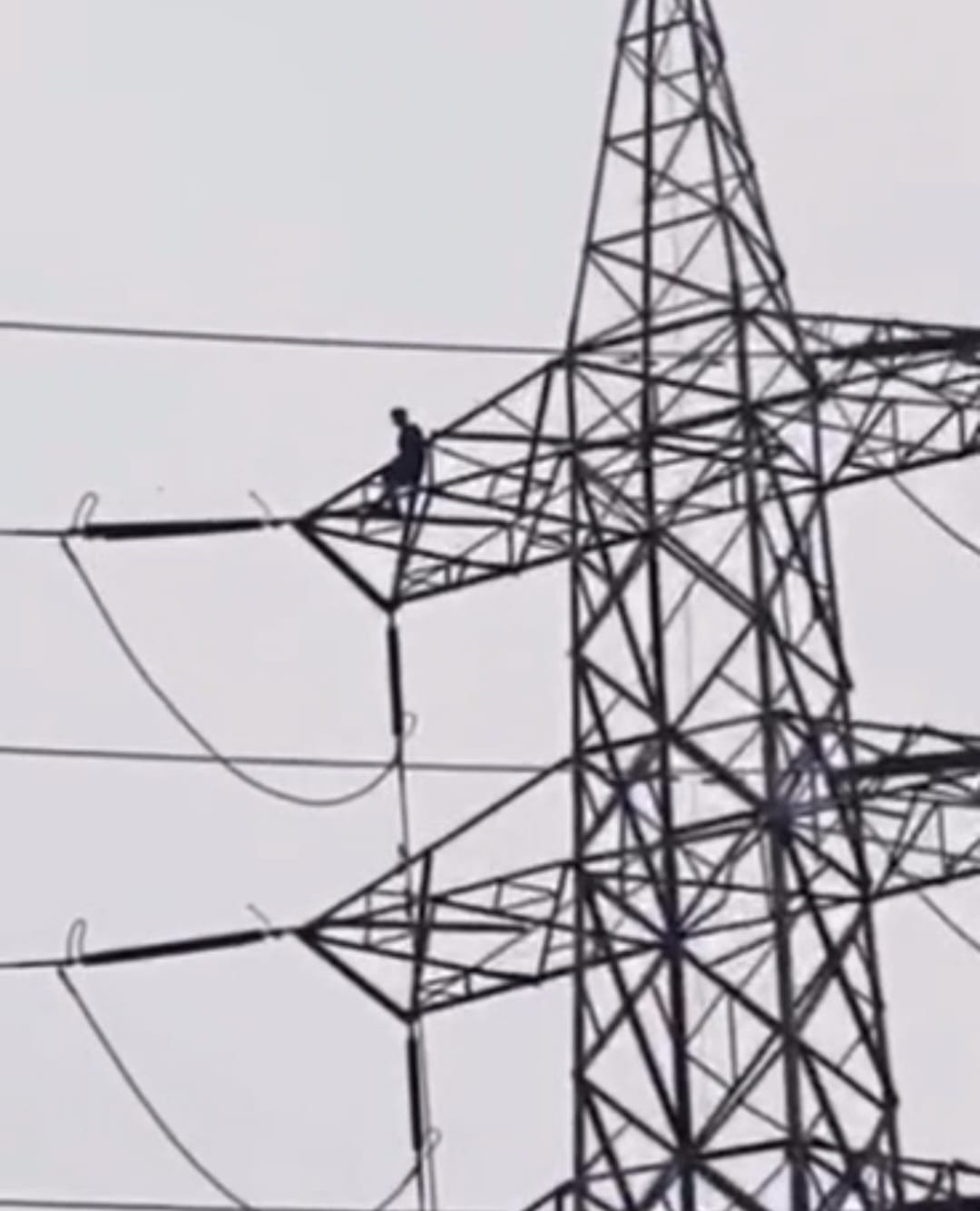 Young man climbs high-tension tower in shock over a broken relationship; brought down safely after a five-hour ordeal.
