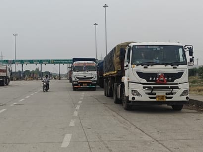 Heavy vehicles parked haphazardly in a no-parking zone.