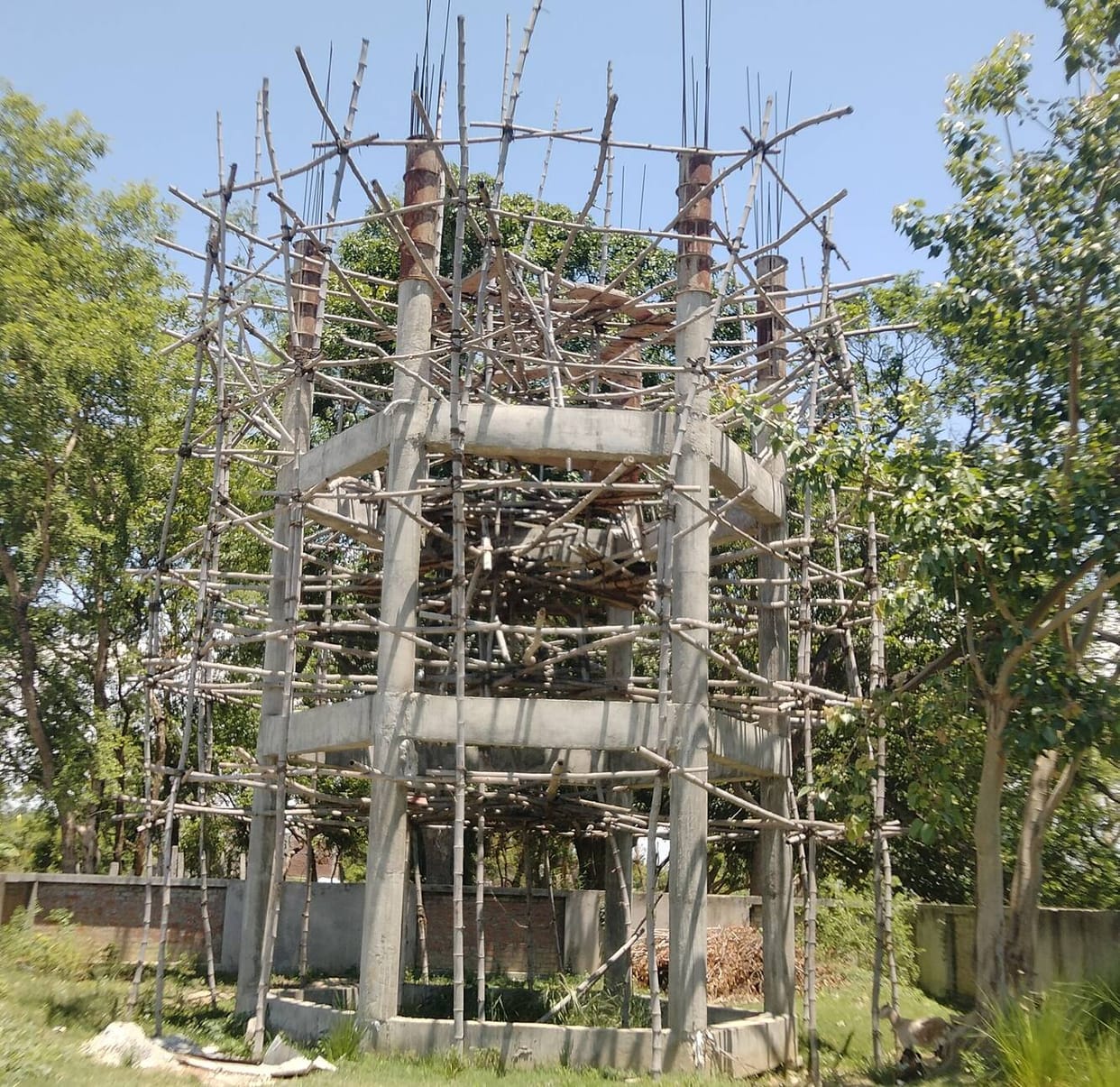 Power lines hanging from bamboo poles-risk of accidents.